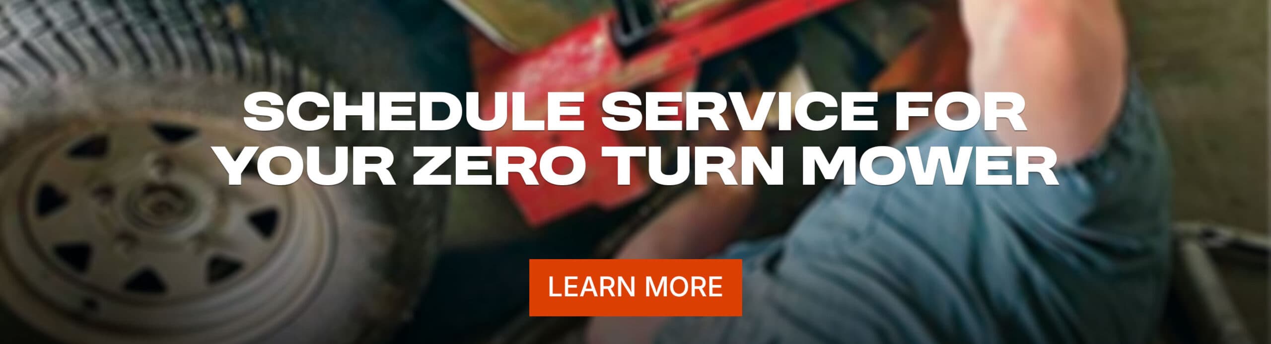 A service technician works on a zero turn lawn mower